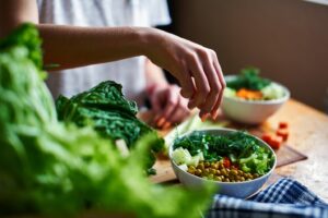 Person preparing salad.